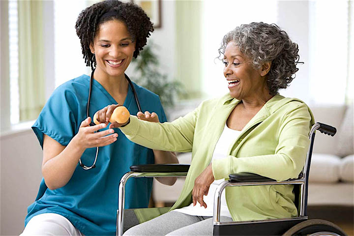 A nurse and an elderly woman in a wheelchair.