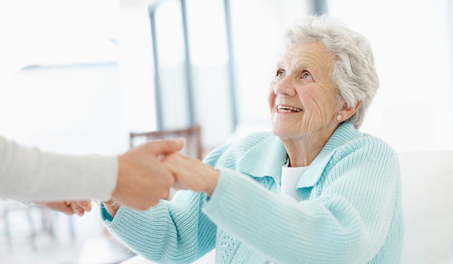 A woman shaking hands with another person.